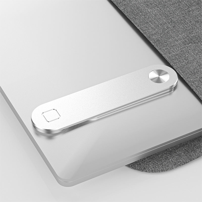Phone mount folded flat on the back of a laptop lid