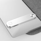 Phone mount folded flat on the back of a laptop lid